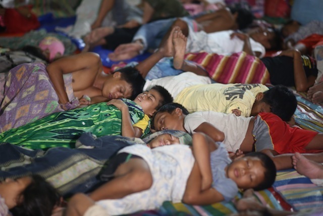 DISPLACED FILIPINOS. People displaced by fighting sleep at an evacuation center in the southern Philippines. File photo by Ferdinandh Cabrera   