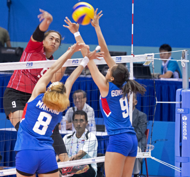 PH volleyball players Aby Marano (L) and Jovelyn Gonzaga (R) attempt to block a spike by Indonesian player Aprilia Santini Manganang. Photo by Singapore SEA Games Organising Committee/Action Images via Reuters 