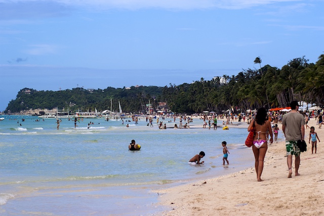 FAMED BEACH. Tourists trek White Beach in Boracay Island. File photo by Angie de Silva/Rappler  