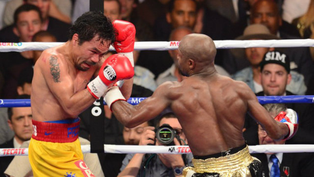 Floyd Mayweather Jr lands a left on Manny Pacquiao during his unanimous decision victory. Photo by Frederic J. Brown/AFP 