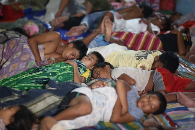 DISPLACED. People displaced by fighting sleep at an evacuation center. File photo by Ferdinandh Cabrera 
