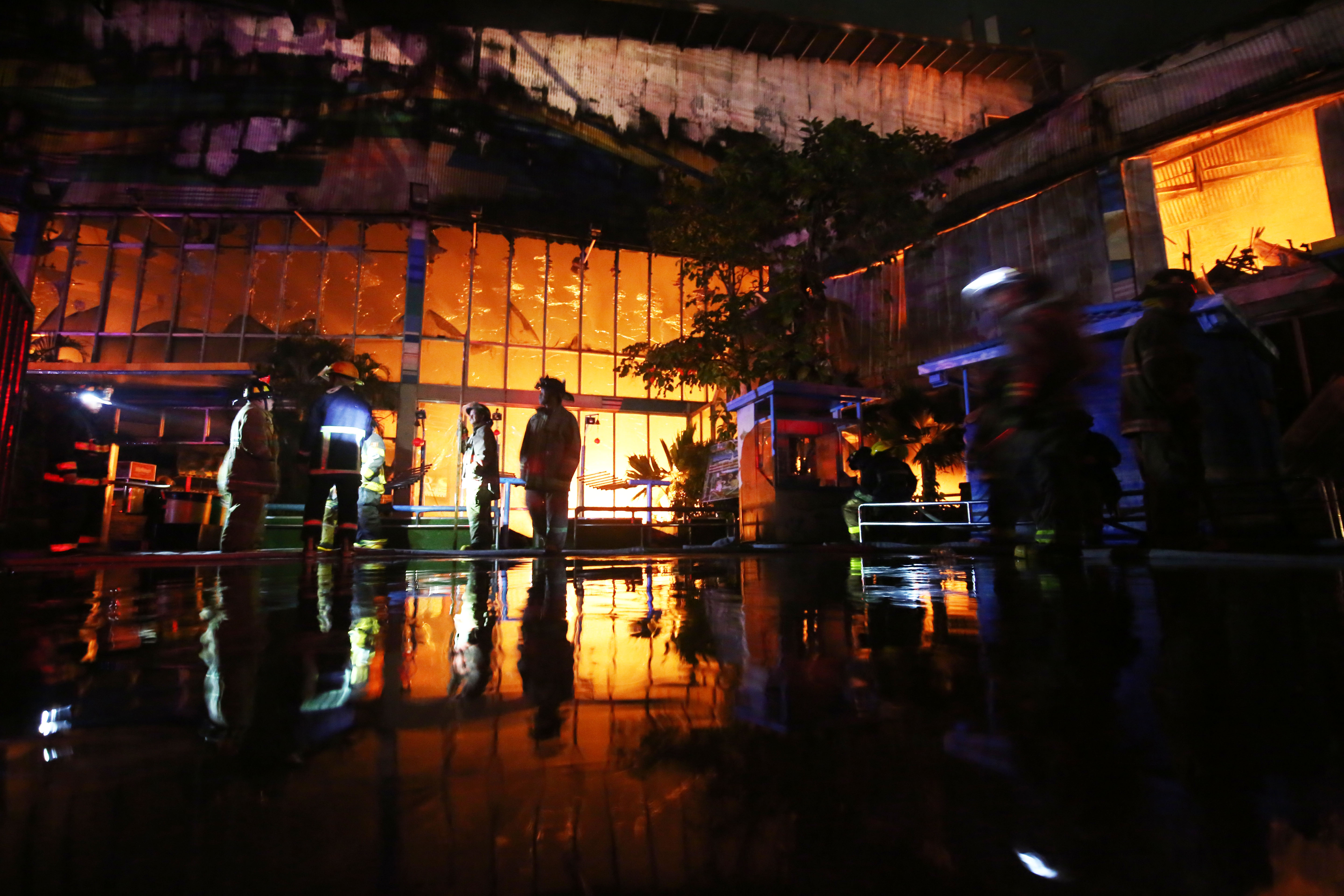 DAWN BLAZE. Firefighters battle the blaze which broke out in the Star City complex in Pasay City. Photo by Ben Nabong  
