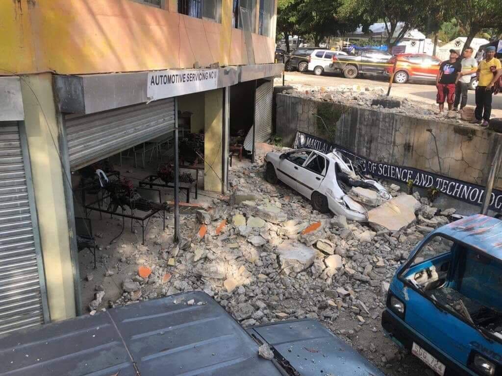 UNSAFE. A car in the area was crushed by falling debris. Photo from QC DRRMC
 