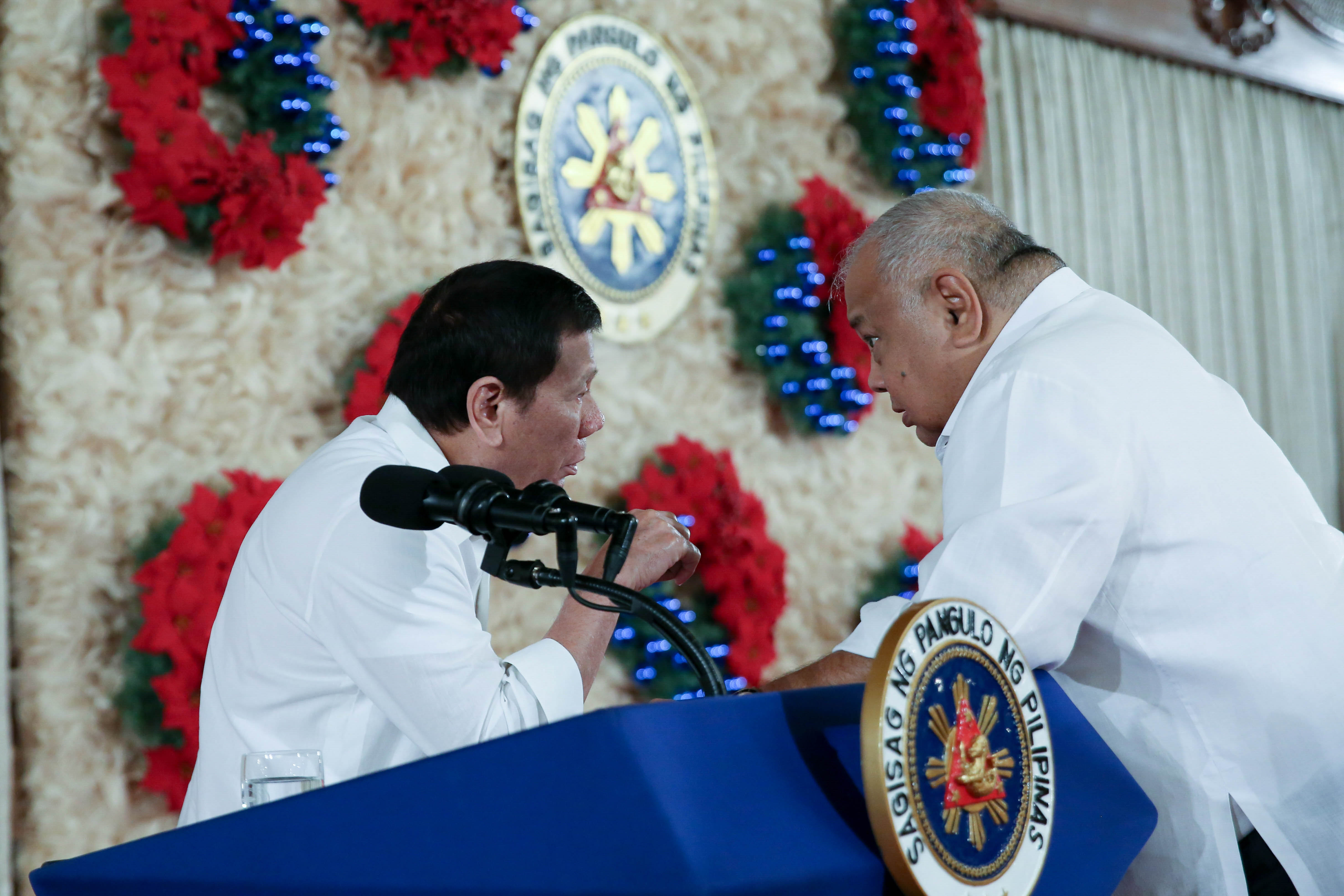 CONFIDANTE. President Duterte confers with Executive Secretary Medialdea during a law-signing ceremony in Malacañang. Malacañang photo