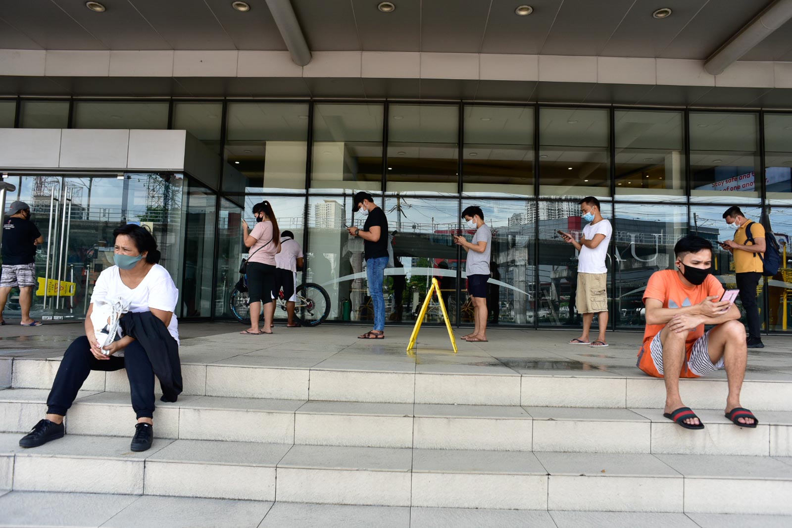 SAFETY FIRST. Face mask-wearing shoppers at SM Megamall practice physical distancing while lining up to enter the premises on May 16, 2020. Photo by Rob Reyes/Rappler 