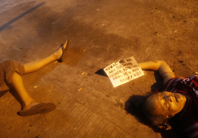 CRIMINALS KILLING CRIMINALS? This photo shows a placard reading 'Do not follow me, I am a drug pusher and my house is a drug den,' next to victims who were shot dead by unidentified gunmen in Manila on July 28, 2016. Photo from EPA