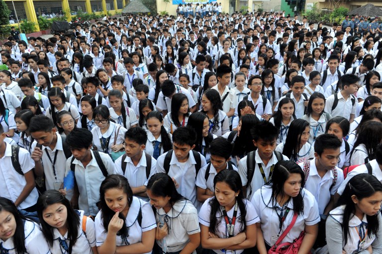 HIGH SCHOOL. Students attend a flag raising ceremony before singing the national anthem at a government school in Manila. File photo by Jay Directo/AFP 