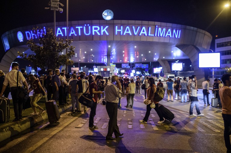 LIMBO. People stand outside the entrance as they leave the airport after two explosions followed by gunfire hit Turkey's biggest airport of Ataturk in Istanbul, on June 28, 2016. Ozan Kose/AFP  
