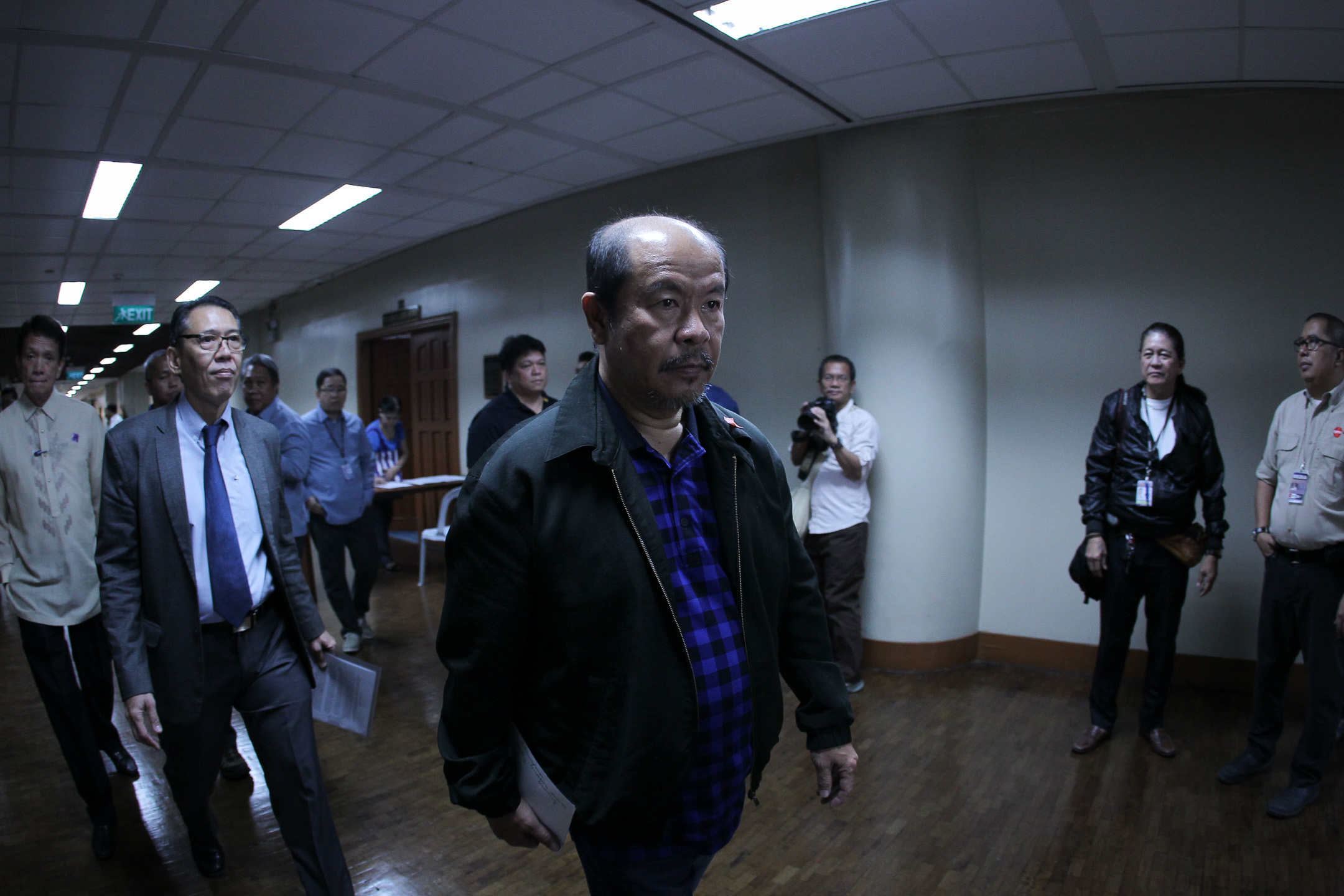 DAVAO COP. Lacsañas is trailed by his lawyers, members of the Free Legal Assistance Group, as he heads to the press conference on February 20. Rappler photo   