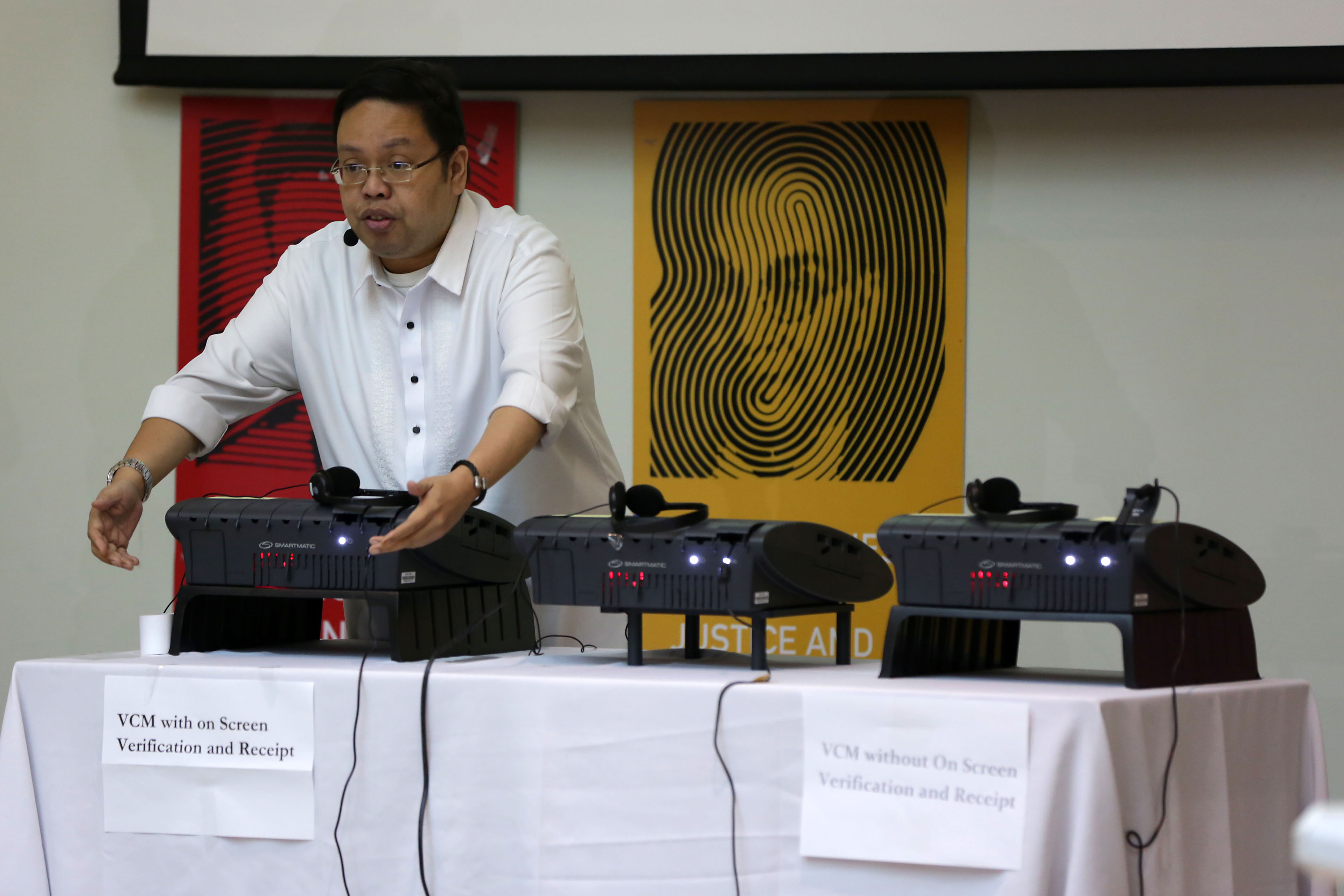 'SYSTEM SECURE.' Comelec Spokesman James Jimenez shows the security features of vote-counting machines before journalists and election watchdogs at the Pope Pius XII Catholic Center in Manila on January 25, 2016. Photo by Ben Nabong/Rappler  