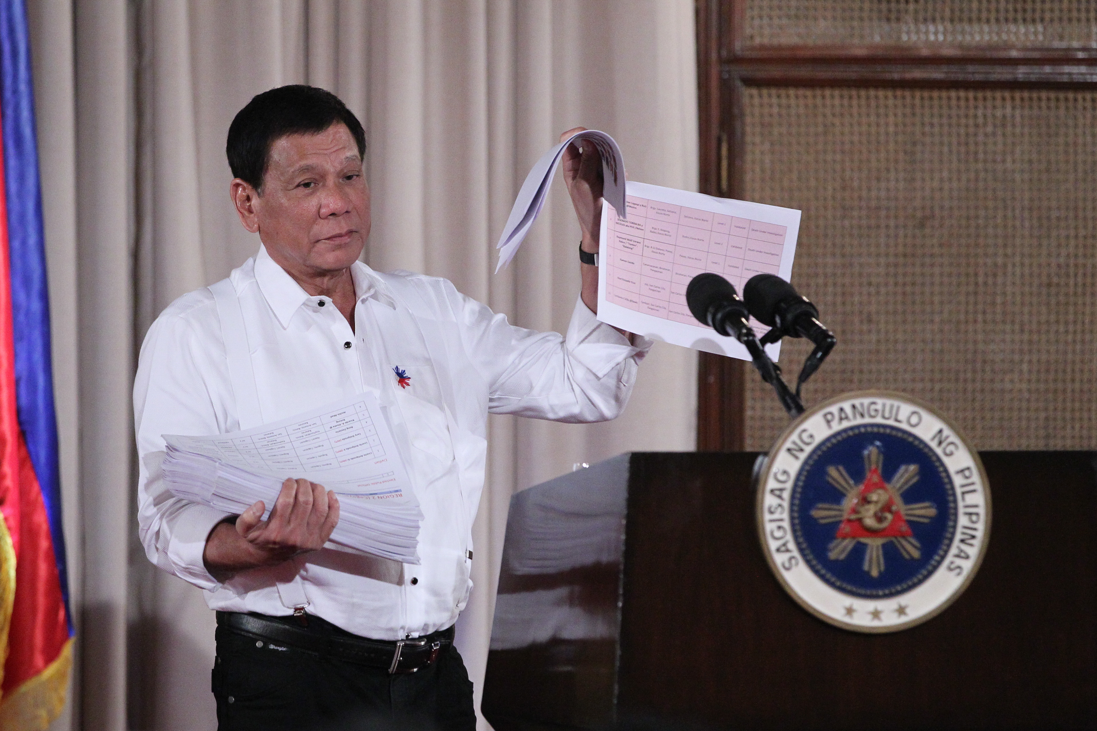 DUTERTE. President Rodrigo Duterte shows a pile of documents containing names of government and police officials who are involved in illegal drug trade at a keynote address in Malacañang on November 28, 2016. Photo by Ace Morandante/Presidential Photo 