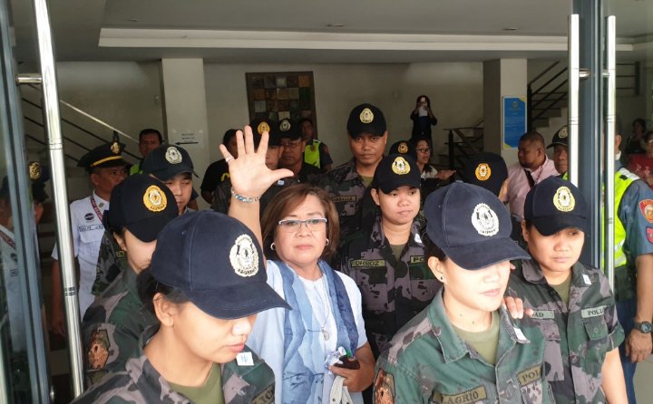 TIGHT  SECURITY. Security escorts bring Senator Leila de Lima out of the Muntinlupa Regional Trial Court. Photo from Office of Senator Leila de Lima 
