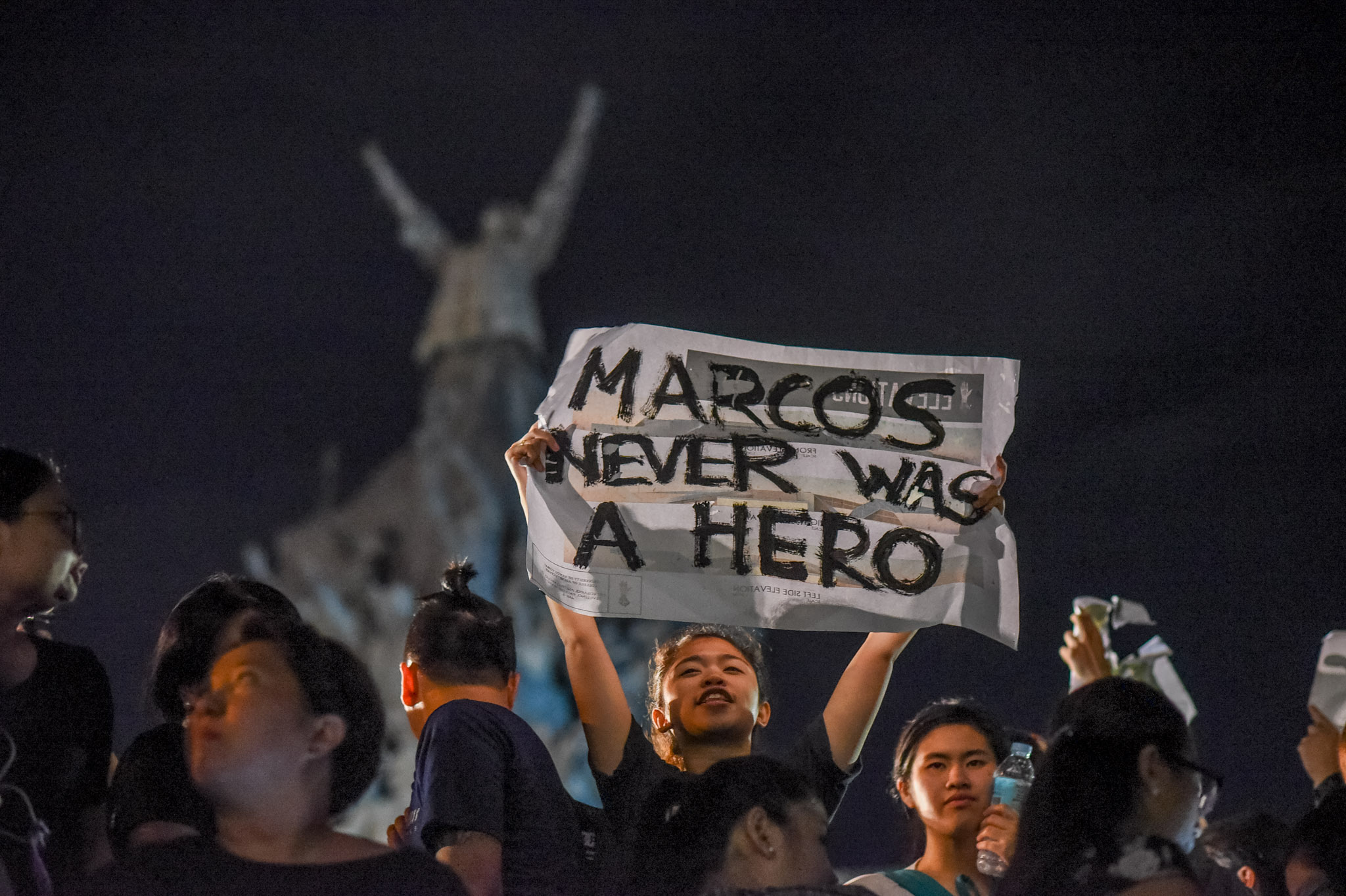 HERO? A protester holds a placard that read' Marcos never was a hero' during a protest at the People Power Monument on November 18, 2016. Photo by Martin San Diego/Rappler 