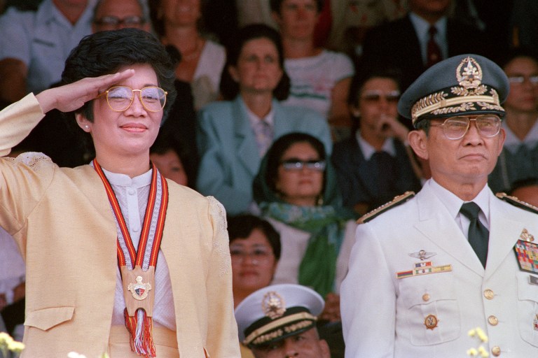COMMANDER-IN-CHIEF. President Cory Aquino and AFP chief of staff Fidel Ramos stand in attention as the 1986 graduates of the Philippine Military Academy pass in review at a commencement exercise in Fort del Pilar, Baguio City. File photo by Romeo Gacad/AFP  