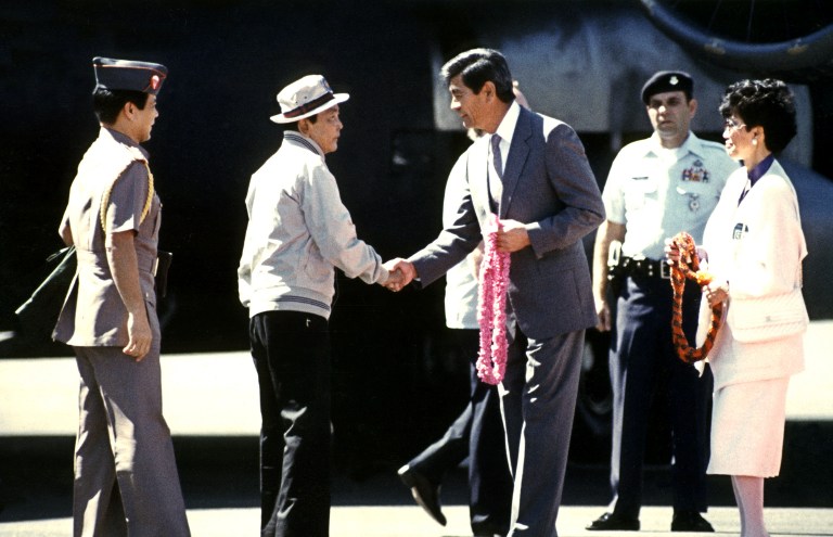 EXILED IN HAWAII. This photo, taken on February 26, 1986, shows Hawaii Governor Jean Ariyoshi (center) greeting ousted Philipppine President Ferdinand Marcos (2nd L) as the deposed president arrives at Hickam Air Force Base in Honolulu from Guam. File photo by AFP 