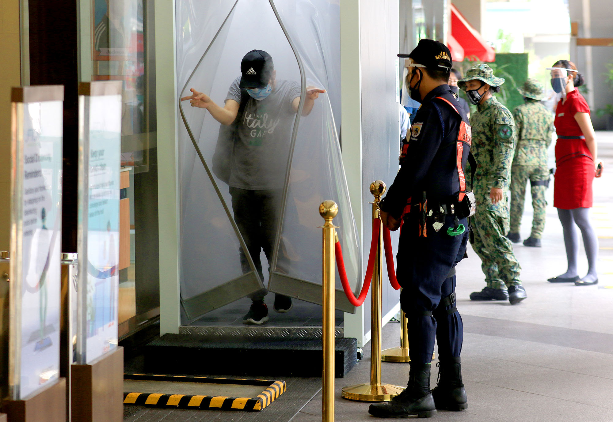 SAFETY. Mall visitors go through a temperature and disinfection channel at the entrance of Uptown Mall in Bonifacio Global City, Taguig City. Photo by Inoue Jaena/Rappler  