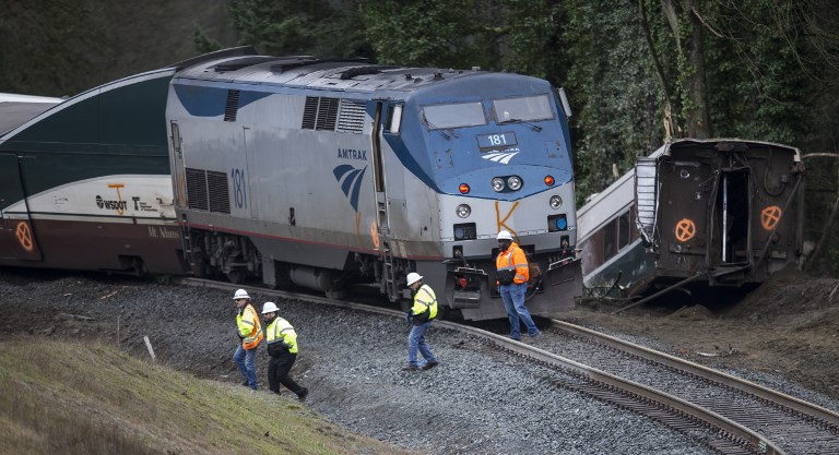 AFTERMATH. Work crews survey the scene of an Amtrak train derailment on December 18, 2017 in DuPont, Washington. Stephen Brashear/Getty Images/AFP 