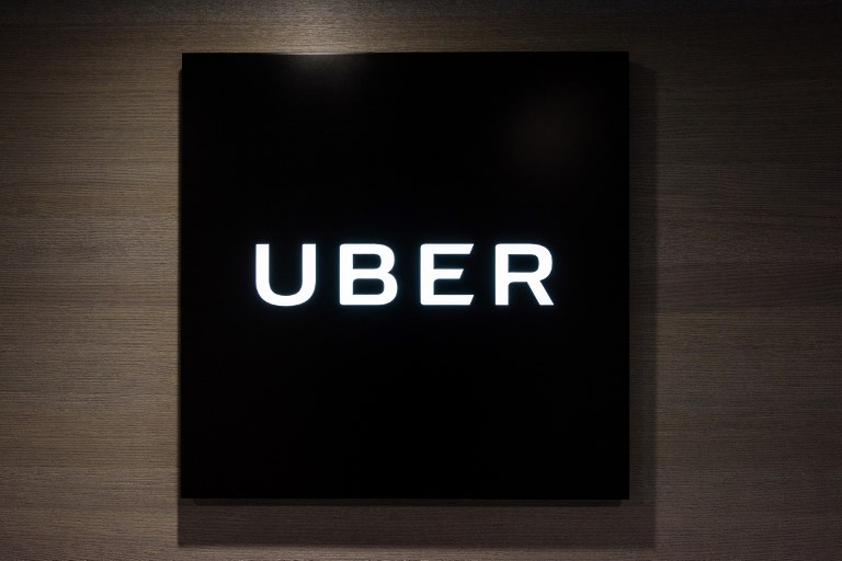 RIDE-SHARING BEHEMOTH. This file photo taken on March 10, 2017 shows Uber signage outside the entrance of the ride-hailing giant's office in Hong Kong. Anthony Wallace/AFP 