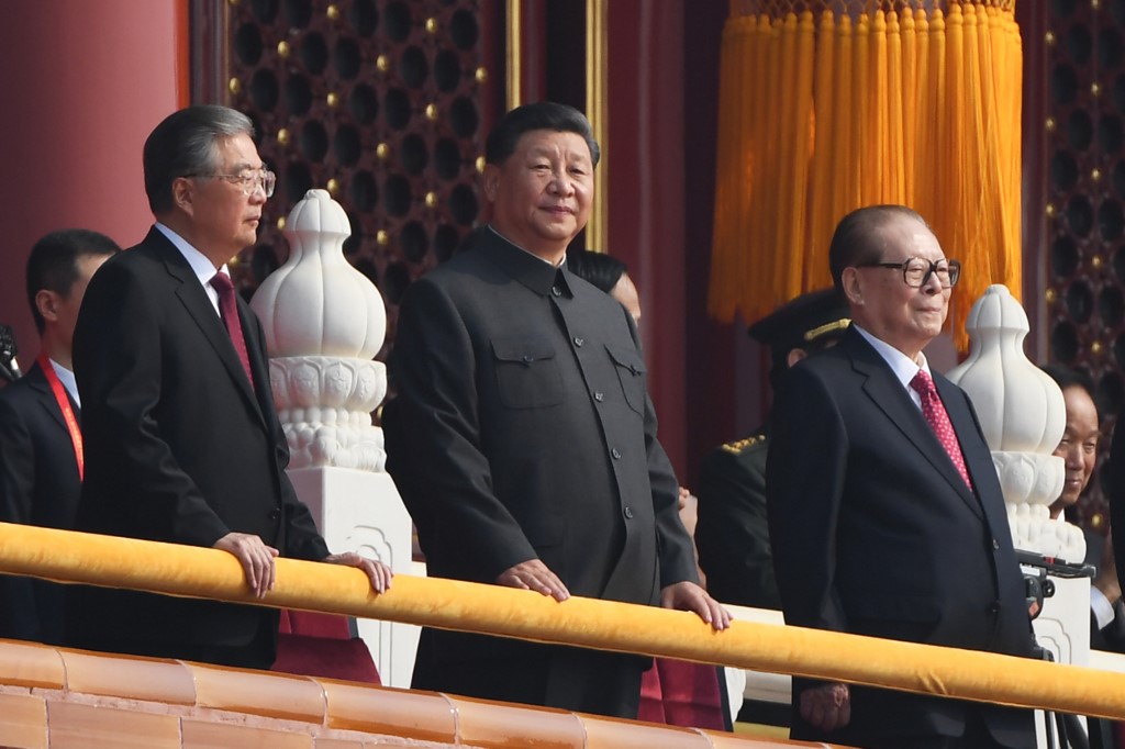 Chinese President Xi Jinping (C) attends a military parade with former presidents Hu Jintao (L) and Jiang Zemin in Tiananmen Square in Beijing on October 1, 2019, to mark the 70th anniversary of the founding of the People's Republic of China. Photo by Greg Baker/AFP  