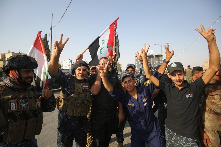 CELEBRATION. Iraqi federal police members flash the sign for victory as they celebrate in the Old City of Mosul. AFP file photo 