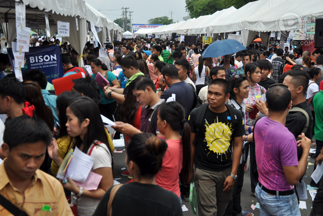 JOB FAIR. Thousands of Filipinos take advantage of a job fair Manila. The ASEAN Economic Community could create an additional 3 million jobs in the Philippines by 2025, compared to a scenario without it, an ILO-ADB study says. File photo/Rappler