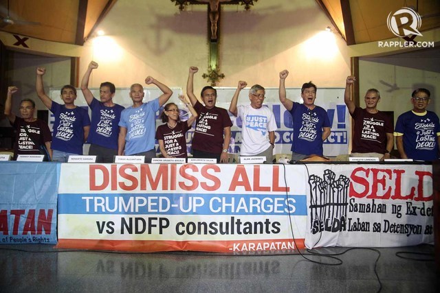 FOR PEACE. Some of the freed political prisoners raise their clenched fists as they hold a press conference at the social hall of the Episcopal Mission Center in Quezon City. Photo by Ben Nabong/Rappler 