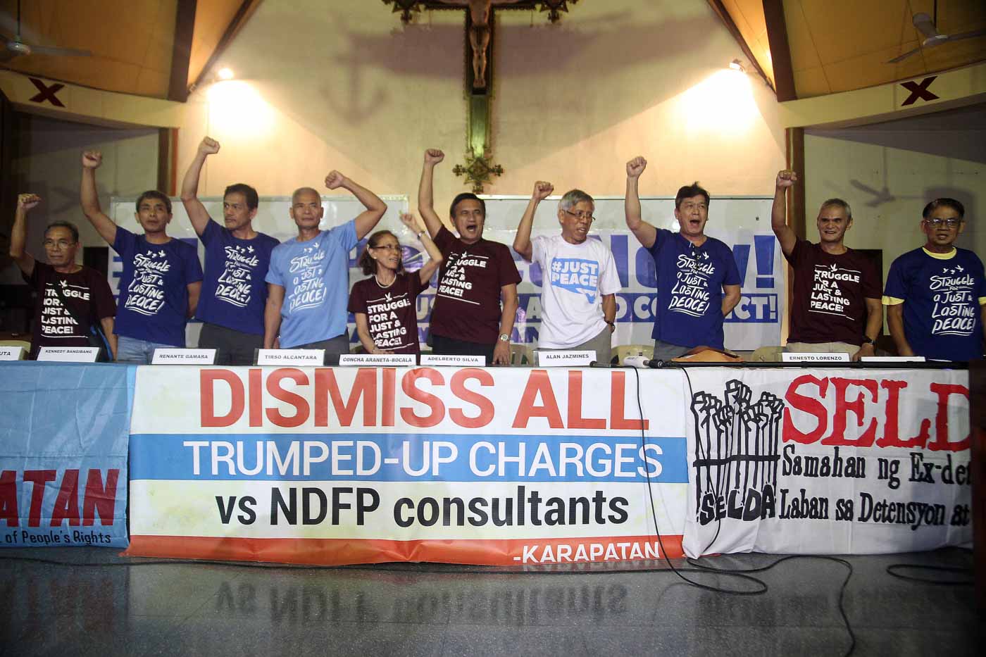 FOR PEACE. Some of the freed political prisoners raise their clenched fists as they hold a press conference at the social hall of the Episcopal Mission Center in Quezon City. Photo by Ben Nabong/Rappler 