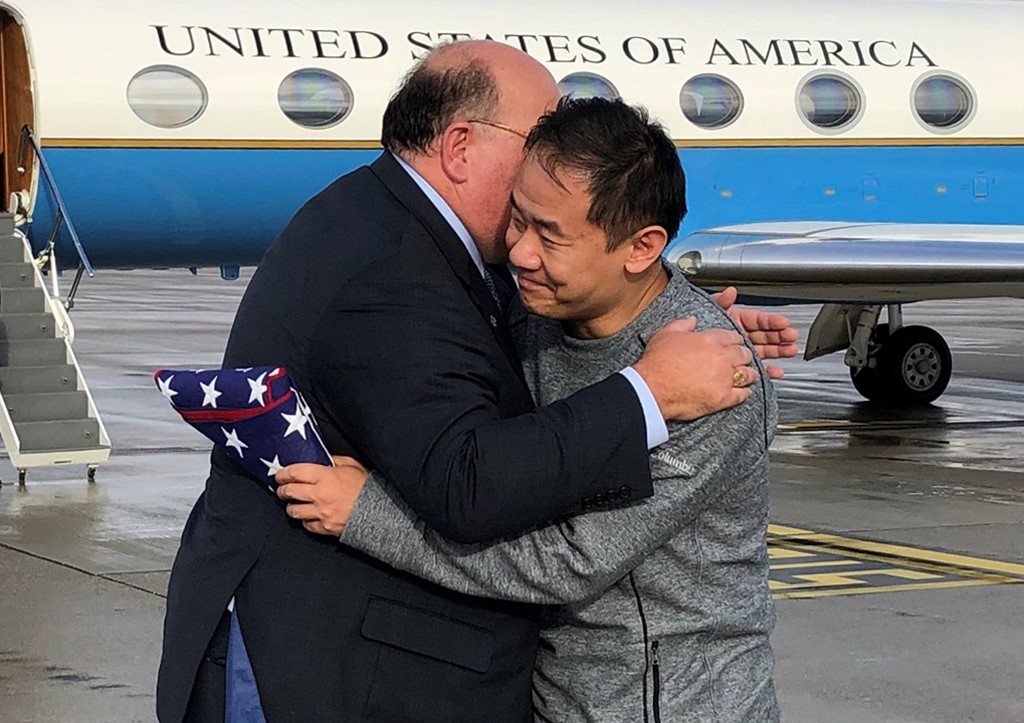 FINALLY FREE. In this image obtained from the US Embassy in Bern, US Ambassador to Switzerland Edward McMullen, Jr., presents a US flag to and welcomes Princeton graduate student Xiyue Wang on arrival in Switzerland after his release from Iran on December 7, 2019. Photo by HO/US State Department/AFP 