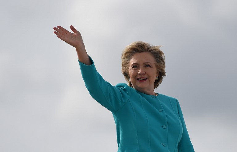 HILLARY CLINTON. Democratic presidential nominee Hillary Clinton waves on her 69th birthday as she boards her plane at Miami International Airport for a day of campaigning in Florida, October 26, 2016. She took time off her campaign in Miami to celebrate her birthday at an Adele concert. Photo by Robyn Beck/AFP PHOTO 