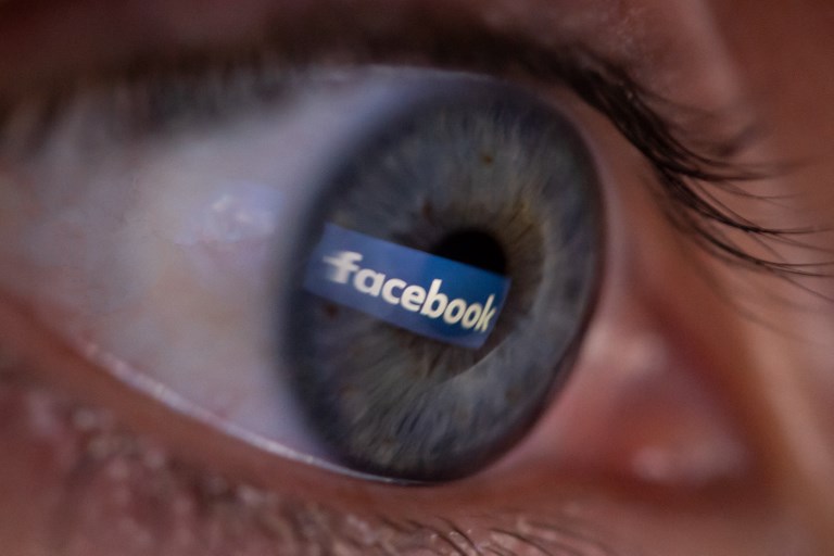 FACEBOOK. An illustration picture shows a person posing during a photo session showing the social platform Facebook logo reflected in the pupil of an eye on April 25, 2018, in Paris. 
File photo by Christophe Simon/AFP 