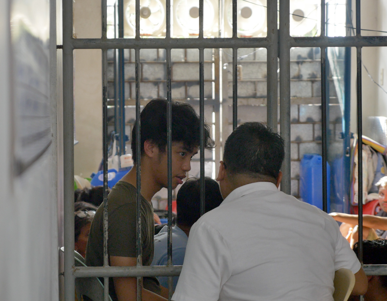 DETAINED. University of the Philippines Diliman student Jon Bonifacio talks to their lawyer on July 31, 2018 at the Meycauayan Police Station. Photo by Naokira Mengua/Rappler 