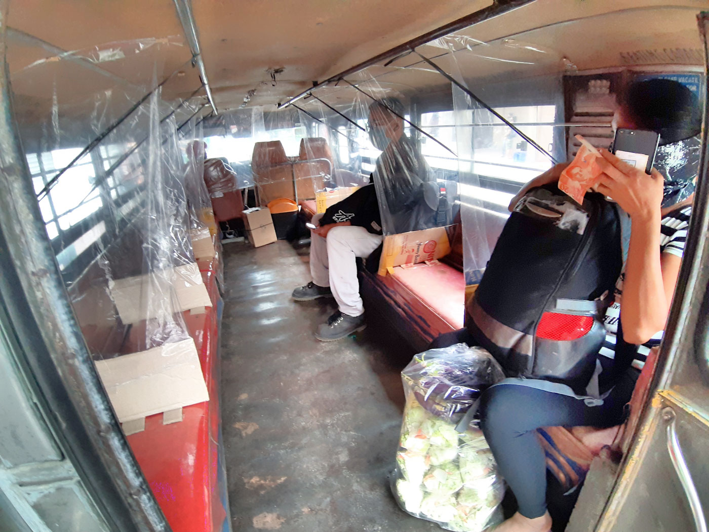 DIVIDERS. A jeepney in Trancoville, Baguio City puts up plastic covers to divide passengers. Photo by Mau Victa/Rappler 