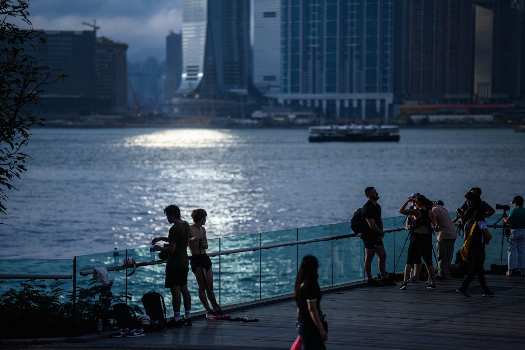 OUTSIDE. People gather to watch the sunset on a viewing platform in Tamar Park overlooking Victoria Harbour and the Kowloon skyline in Hong Kong on May 5, 2020. Photo by Anthony Wallace/AFP 