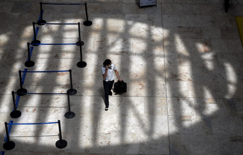 QUARANTINE. A passenger walks at an empty hall of the Madrid-Barajas Adolfo Suarez Airport's Terminal 4 in Barajas on May 5, 2020, amid the national lockdown to prevent the spread of the COVID-19 disease. File photo by Oscar Del Pozo/AFP 