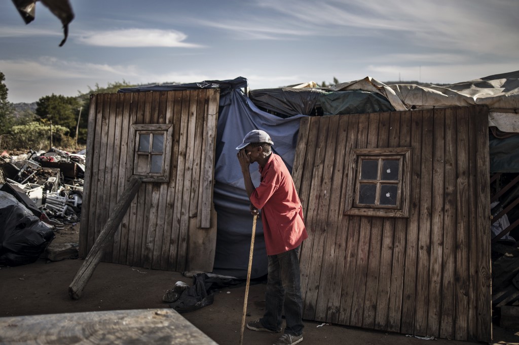 VULNERABLE. A resident of Plot 323 in Wilgespruit, Johannesburg, South Africa, pauses in front of a wooden shack on May 8, 2020. Photo by Marco Longari/AFP 
