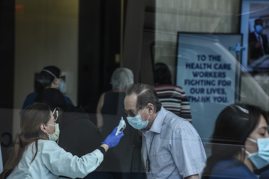 TEMPERATURE CHECK. A person gets his temperature checked before being allowed into a Mt. Sinai Hospital building on May 4, 2020 on the Upper East Side neighborhood in New York City. File photo by Stephanie Keith/Getty Images/AFP 