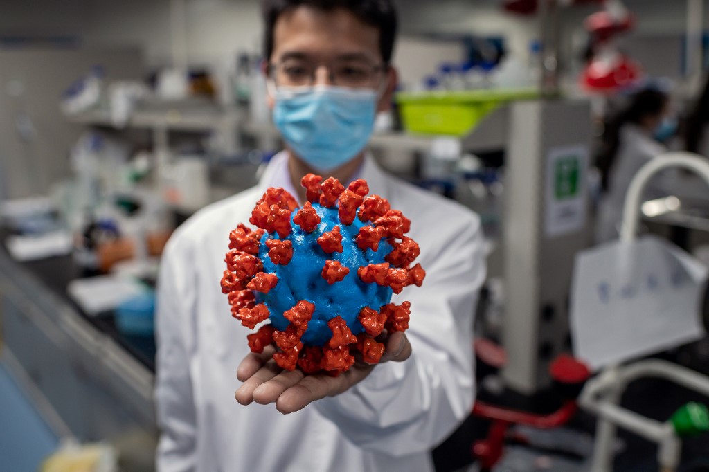 POTENTIAL CURE. An engineer shows a plastic model of the COVID-19 coronavirus at the Quality Control Laboratory of the Sinovac Biotech facilities in Beijing. Photo by Nicolas Asfouri/AFP  