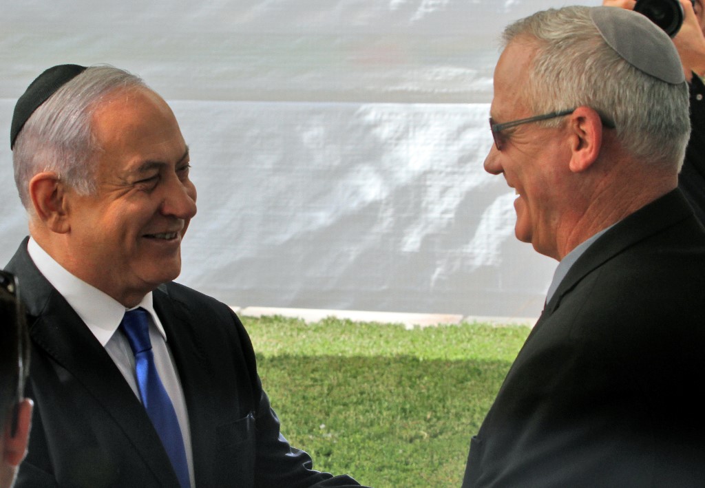 UNITY. In this file photo, Israeli Prime Minister Benjamin Netanyahu (L) greets Benny Gantz, leader of Blue and White party, at a memorial ceremony for late Israeli president Shimon Peres, at Mount Herzl in Jerusalem on September 19, 2019. File photo by Gil Cohen-Magen/AFP 