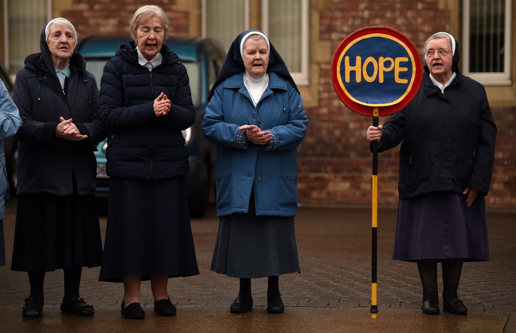 SISTERS. Nuns sing and clap to show their appreciation of Britain's NHS (National Health Service) workers and other frontline medical staff around the country as they battle with the novel coronavirus pandemic. Photo by Oli Scarff/AFP 