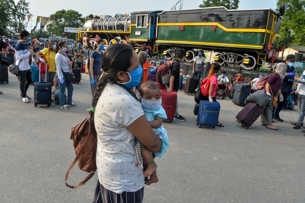 EASING LOCKDOWN. Migrant passengers from Sikkim state wait for transportation after they arrived from Chennai at New Jalpaiguri railway station, India, on May 14, 2020. Photo by Diptendu Dutta/AFP 