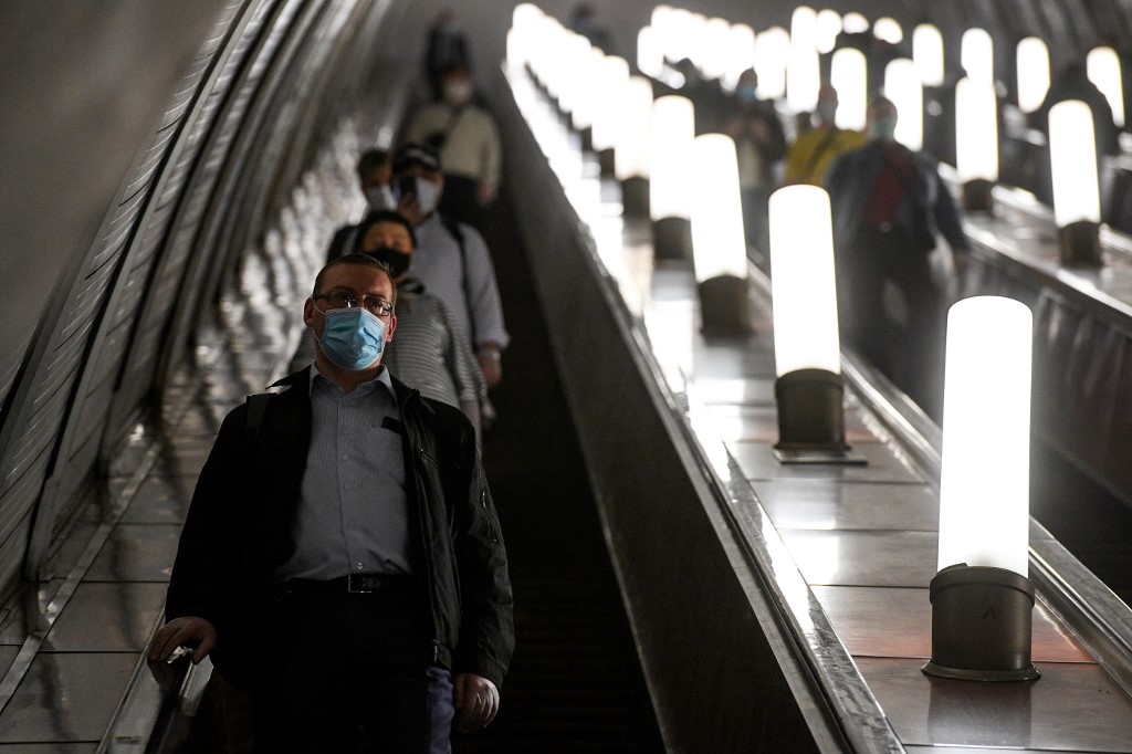 GOING DOWN. People wearing face masks ride an escalator at Savyolovskaya metro station on the first day of mandatory use of masks and gloves on Moscow public transport, in Moscow on May 12, 2020, amid the coronavirus pandemic. Photo by Kirill Kudryavtsev/AFP 