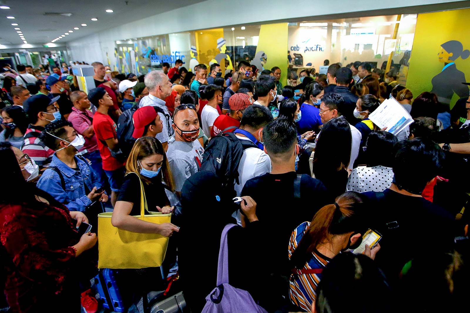 FLIGHTS CANCELED. Passengers flock the ticketing office of Cebu Pacific to book and rebook flights at the NAIA Terminal 3 in Pasay City on March 13. Photo by Inoue Inoue Jaena/Rappler 