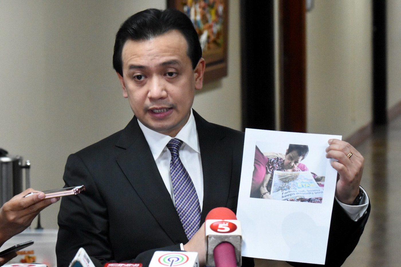 DENIALS. Senator Antonio Trillanes IV denies President Rodrigo Duterte's allegations. Here he is showing the photo of his 84-year-old mother, after being implicated by the President. Photo by Angie de Silva/Rappler  