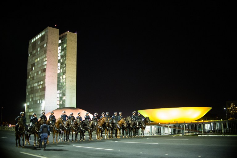 TIGHT SECURITY. Mounted police stand guard outside the National Congress in Brasilia on May 11, 2016, after a turmoil caused by demonstrators. Photo by Andressa Anholete/AFP  