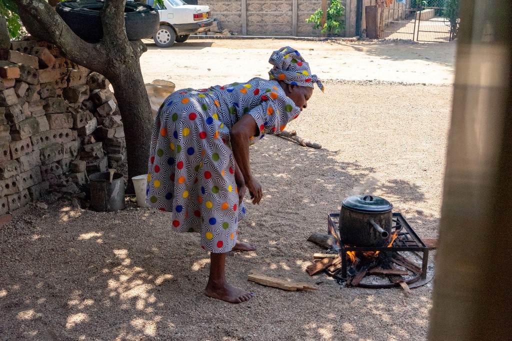 TOUGH TIMES. An elderly woman cooks at her home in Emakhandeni Bulawayo, Zimbabwe, on March 2, 2019. File photo by Zinyange Auntony/AFP 