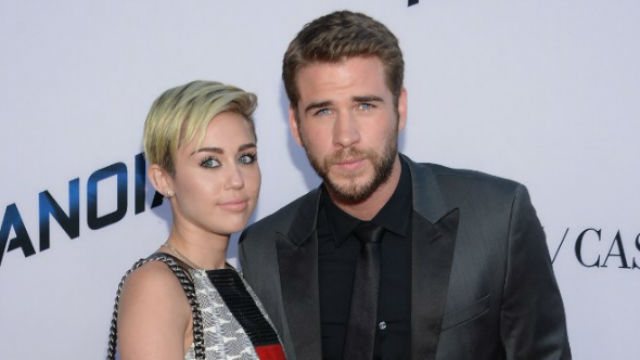 ENGAGED AGAIN. Liam Hemsworth and Miley Cyrus are engaged again after splitting in 2013. In the photo, the couple is at the premiere of 'Paranoia on August 8, 2013 in Los Angeles. File photo by Jason Kempin/Getty Images North America/APF 