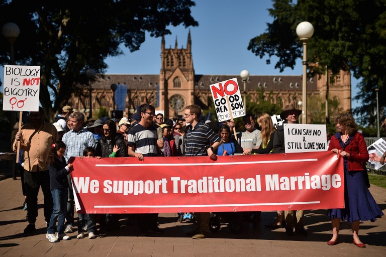 OPPOSED. This picture taken on September 9, 2017 shows protesters holding up banners at an anti same-sex marriage rally in Sydney. Peter Parks/AFP 