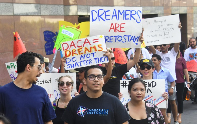 In this file photo, young immigrants and supporters walk holding signs during a rally in support of Deferred Action for Childhood Arrivals (DACA) in Los Angeles, California on September 1, 2017. Frederick J Brown/AFP 