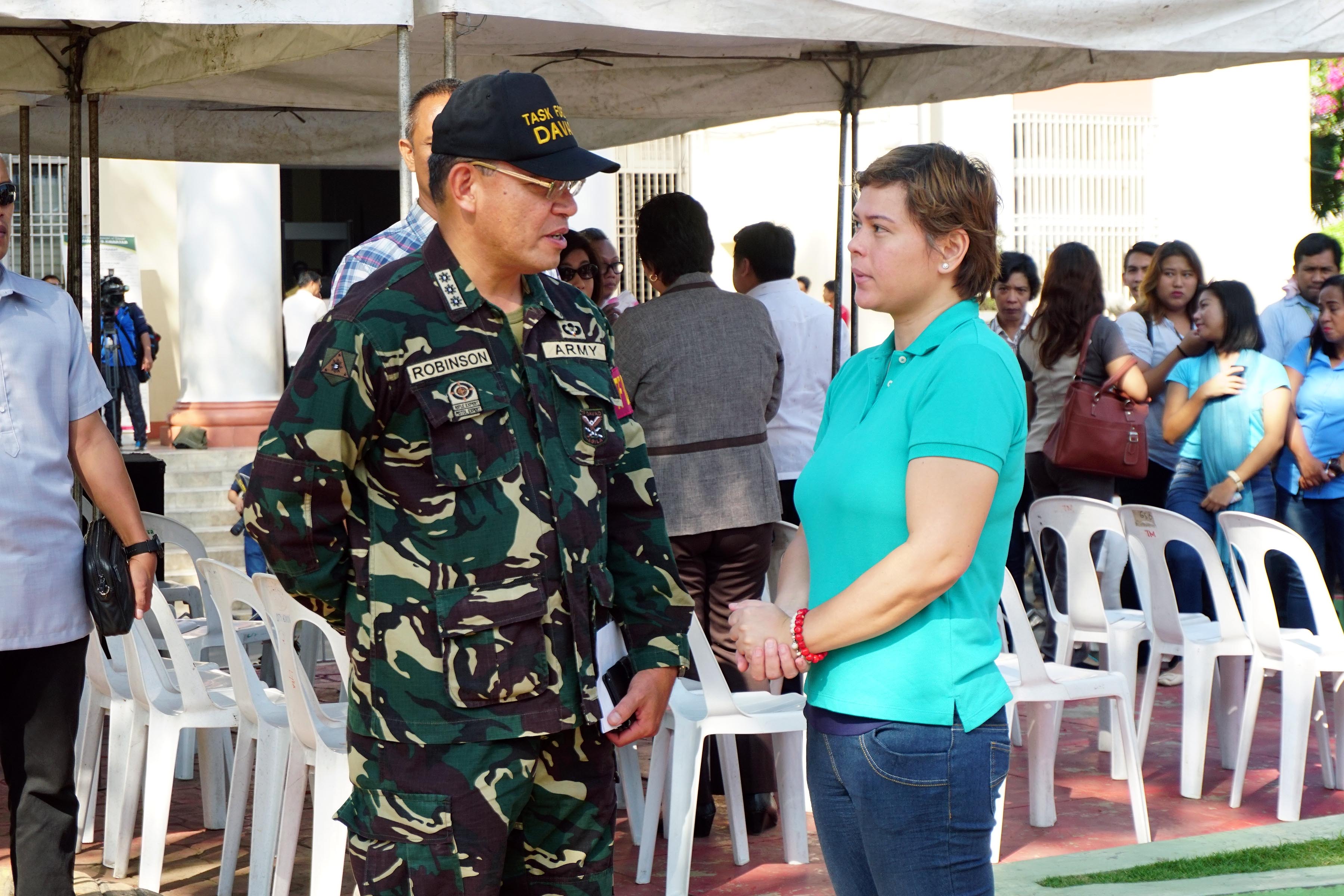 MAYOR SARA. Mayor Sara Duterte-Carpio talks with the commander of Task Force Davao, Colonel Henry Robinson Jr, after the flag raising ceremony of the City Government on September 5, 2016. Photo by JFP Dalumpines 