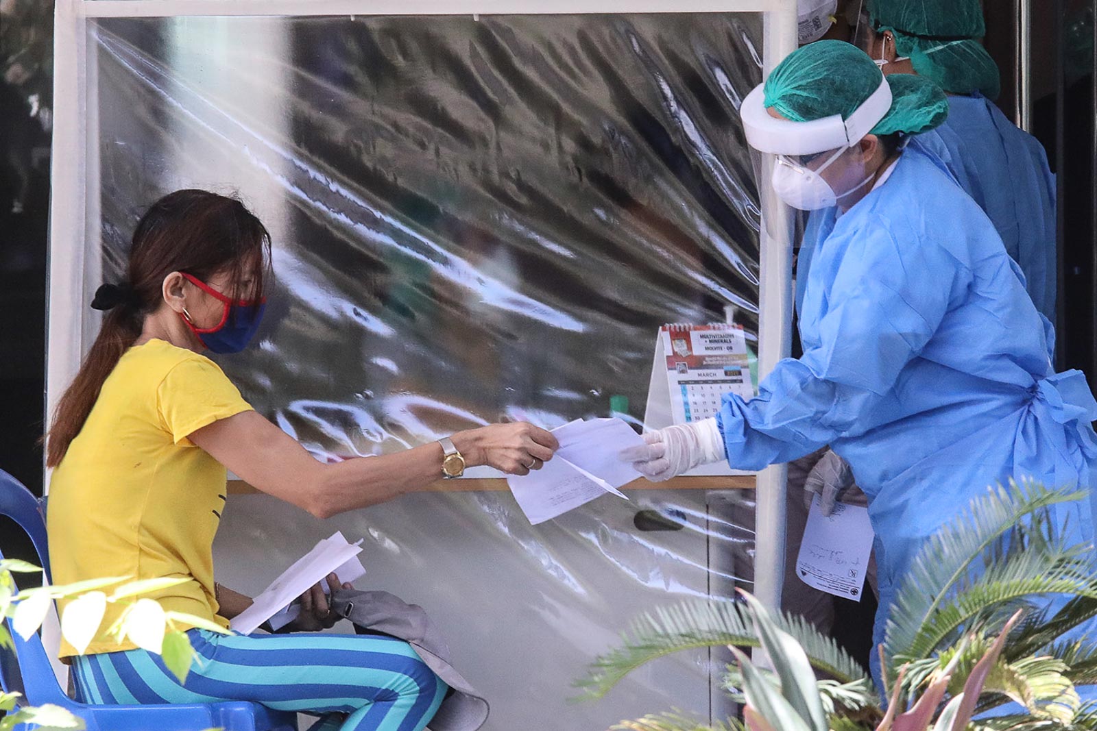 PROTECTION. The Rosario Maclang Bautista General Hospital on March 30, installs plastic dividers to separate health workers from patients as a precautionary measure to contain the spread of the coronavirus. Photo by Darren Langit/Rappler  